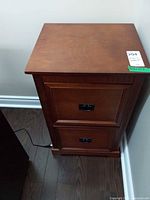 Front view of nightstand showing two drawers and cherry finish