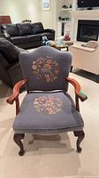 Full view of upholstered armchair showing frame, legs, arms, seat and back