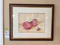 Full view of framed watercolor still life in wood frame with gold trim