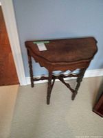 Full view of demi-lune side table against wall