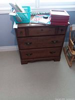 Front view of dresser showing three drawers and hardware