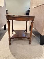 Full front view of oval side table between chairs
