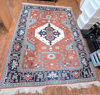 Full view of rug showing overall design, colors, size and fringe