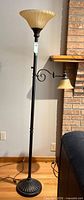 Full view of bronze floor lamp with two glass shades