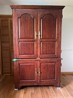 Full front view of two-piece cabinet showing double-door upper and lower sections