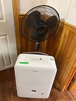 Danby dehumidifier front view with WeatherWorks pedestal fan behind