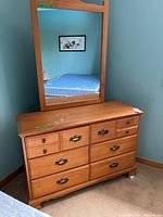 Front view of dresser and attached mirror showing drawer configuration and handles