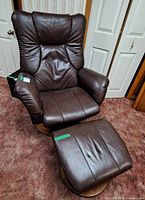Front view of recliner and ottoman showing leather upholstery and wood bases