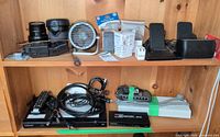 Overall view of electronics, camera gear, switches and cables on shelf