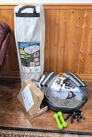 Group shot showing air mattress carry bag, truMedic massager in case, dumbbells, boxed U-lock, paperwork