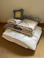 Stack showing comforter, shams, topper and decorative pillow