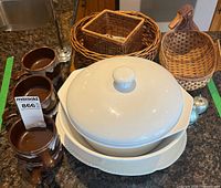 Group shot showing casserole, platter, soup bowls, wicker baskets