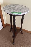 Full view of marble-top pedestal table