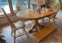 Dining table with chairs and one leaf inserted