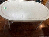 Full view of oval table top showing laminate surface and decorative edging
