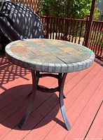 Full view of round mosaic tile table on deck