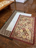 Three rugs stacked showing patterns and relative sizes
