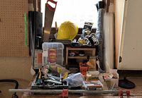 Overall lot showing clamp, saw, hat, vise, fasteners