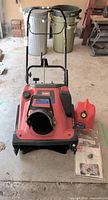 Front view of Toro CCR 3650 snow blower, fuel can, manuals