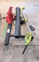 Toro blower-vac, Sunjoe trimmer, large black attachment tube on floor