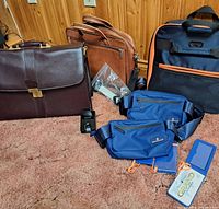 Group shot showing briefcase, messenger bag, rolling bag, waist packs and accessories