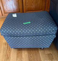 Top view of upholstered ottoman showing overall pattern and shape