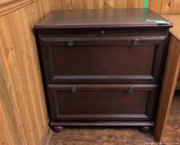 Front view of wood filing cabinet showing two drawers and overall style