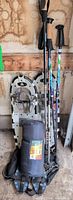 Full view of snowshoes, poles, sleeping bag and ice cleats