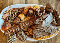 Plate of assorted Turkish kebabs and sides, illustrative of restaurant offerings