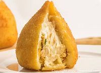 Fried, breaded, tear-drop shaped snack with creamy chicken filling, likely menu item representation