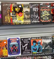 Store merchandise shelves with books and records illustrating retailer