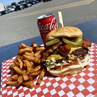 Burger, fries and drink promotional image representing restaurant