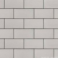Close-up of light gray rectangular pavers in subway layout