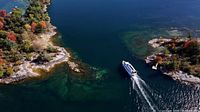 Aerial view of 1000 Islands waterway with tour boat for illustrative context