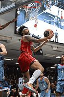 Player in red Ottawa BlackJacks uniform driving to the basket during game