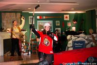Performer in Oh Canada Eh?! musical holding hockey stick, contextual image