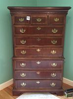 Front view of dresser showing brass hardware and glass top