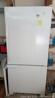 Full frontal view of the white Kenmore refrigerator showing the two-door design with freezer at the bottom.
