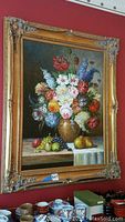 Full view of the framed oil on canvas floral and fruit still life painting.