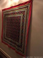 Wall tapestry hanging on a wall showing full pattern and colors