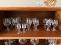 Cabinet shelf showing full set of 14 Waterford Boyne stemware in three sizes