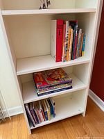 Full bookcase view showing three shelves and quantity of books