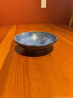 Oblique view of blue pottery bowl showing exterior glaze and profile