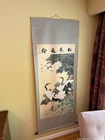 Full view of scroll on wall showing artwork and mounting