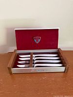 Open presentation case showing all four knives in slots