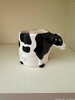 Left side view of ceramic cow mug