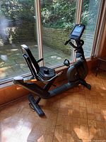 Left side profile of Horizon Fitness Comfort R recumbent bike showing seat, console, pedals