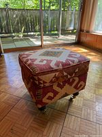 Front angle showing overall ottoman, textile pattern, casters