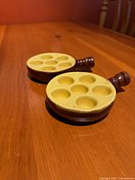 Top view of both escargot dishes showing six wells and handles