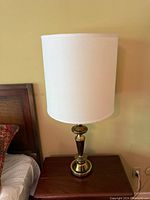 Lamp on nightstand showing full lamp with shade